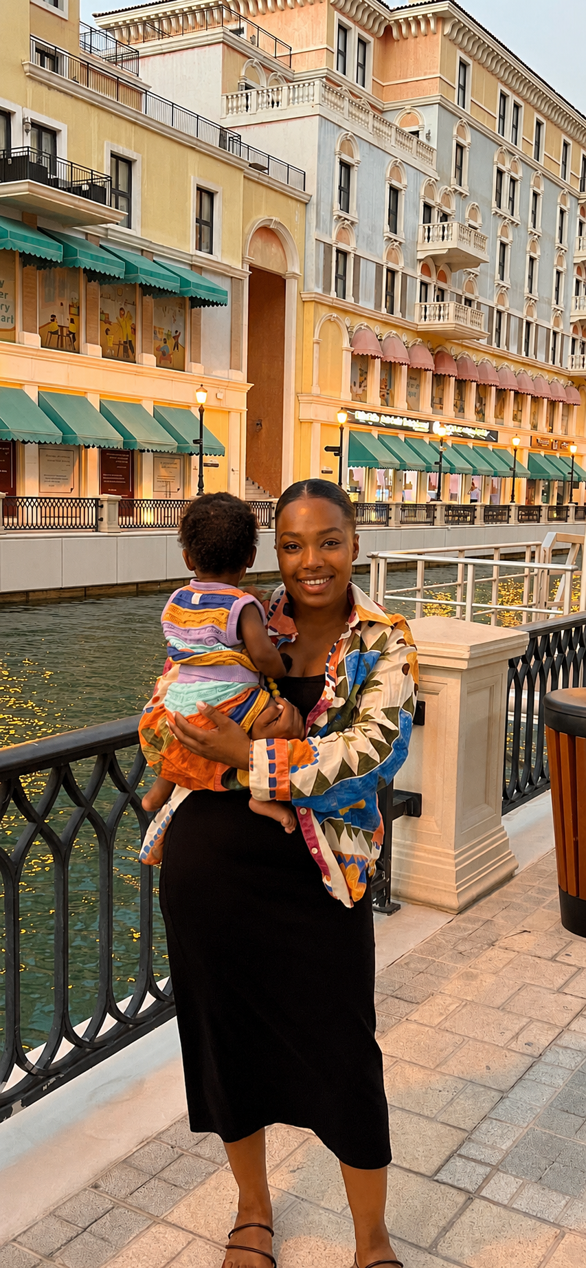 Shakila, founder of Mère + Me, holding her daughter